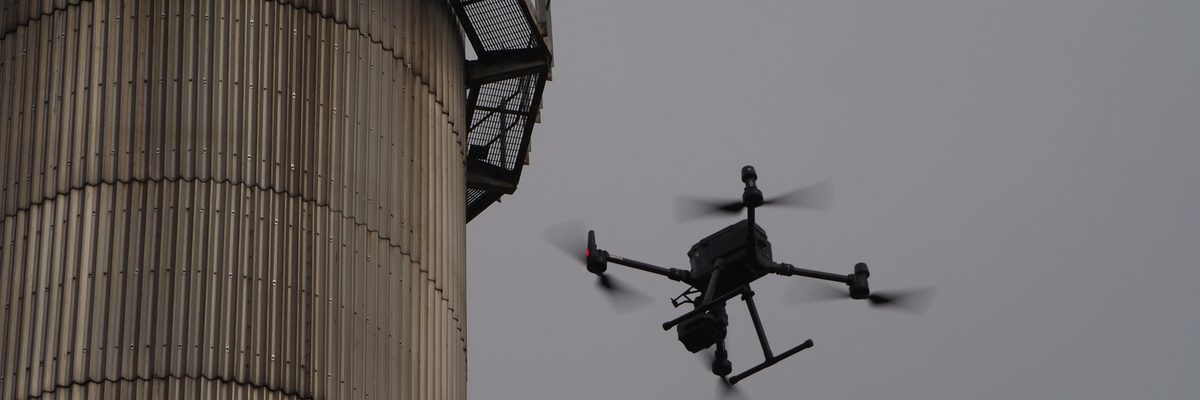 A drone inspecting an industrial chimney stack