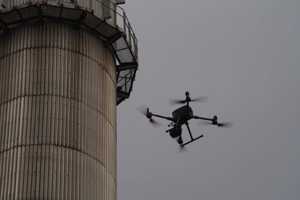 A drone inspecting an industrial chimney stack