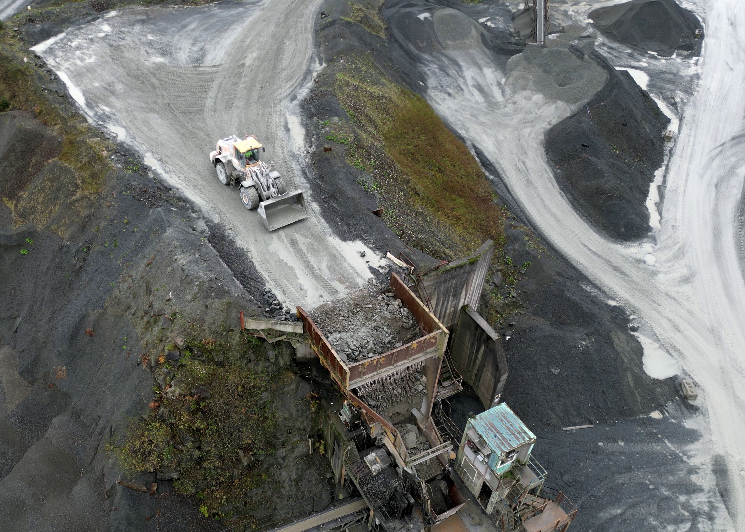 An aerial image of a quarry with a loader operating