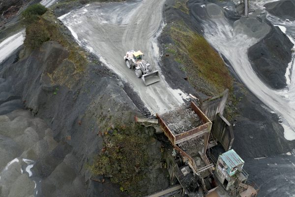 An aerial image of a quarry with a loader operating