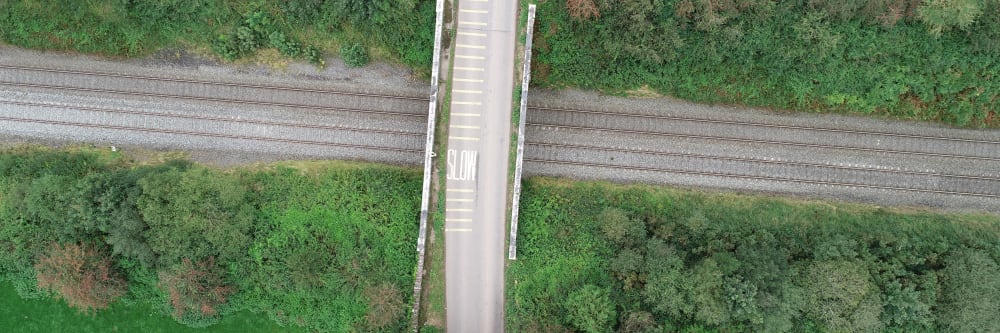 A photo of a railway tracks and a bridge taken with a drone