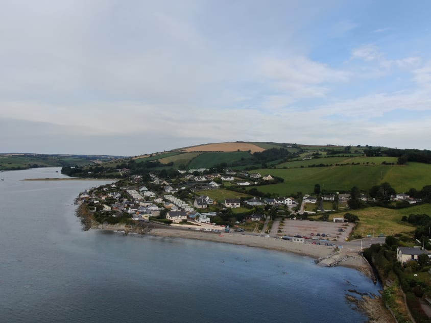 A view of a town next to the sea taken by a drone performing services for real estate.