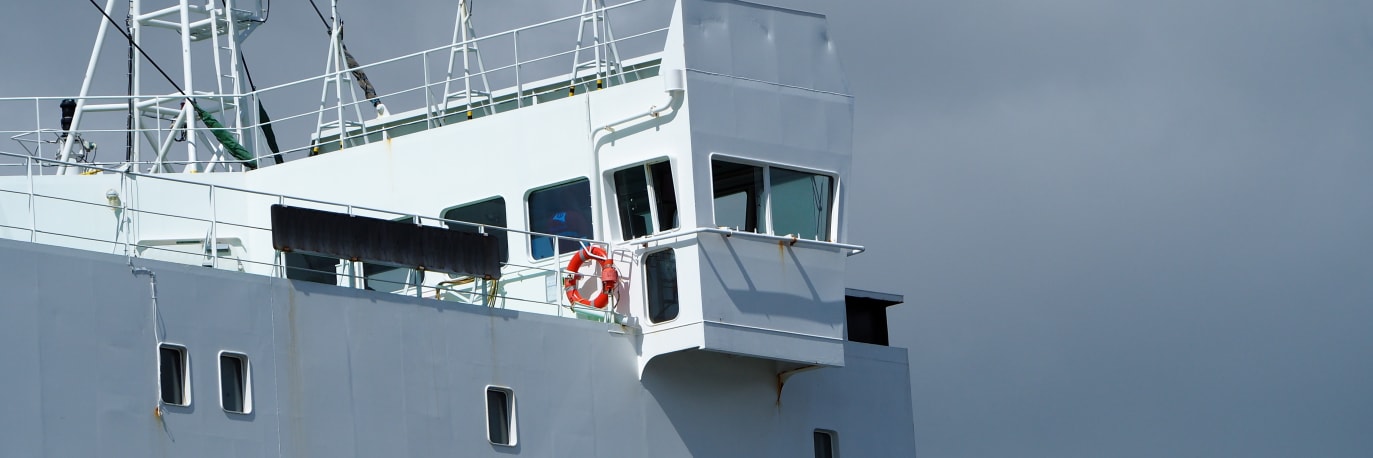 A photo of a ship being inspected by a drone