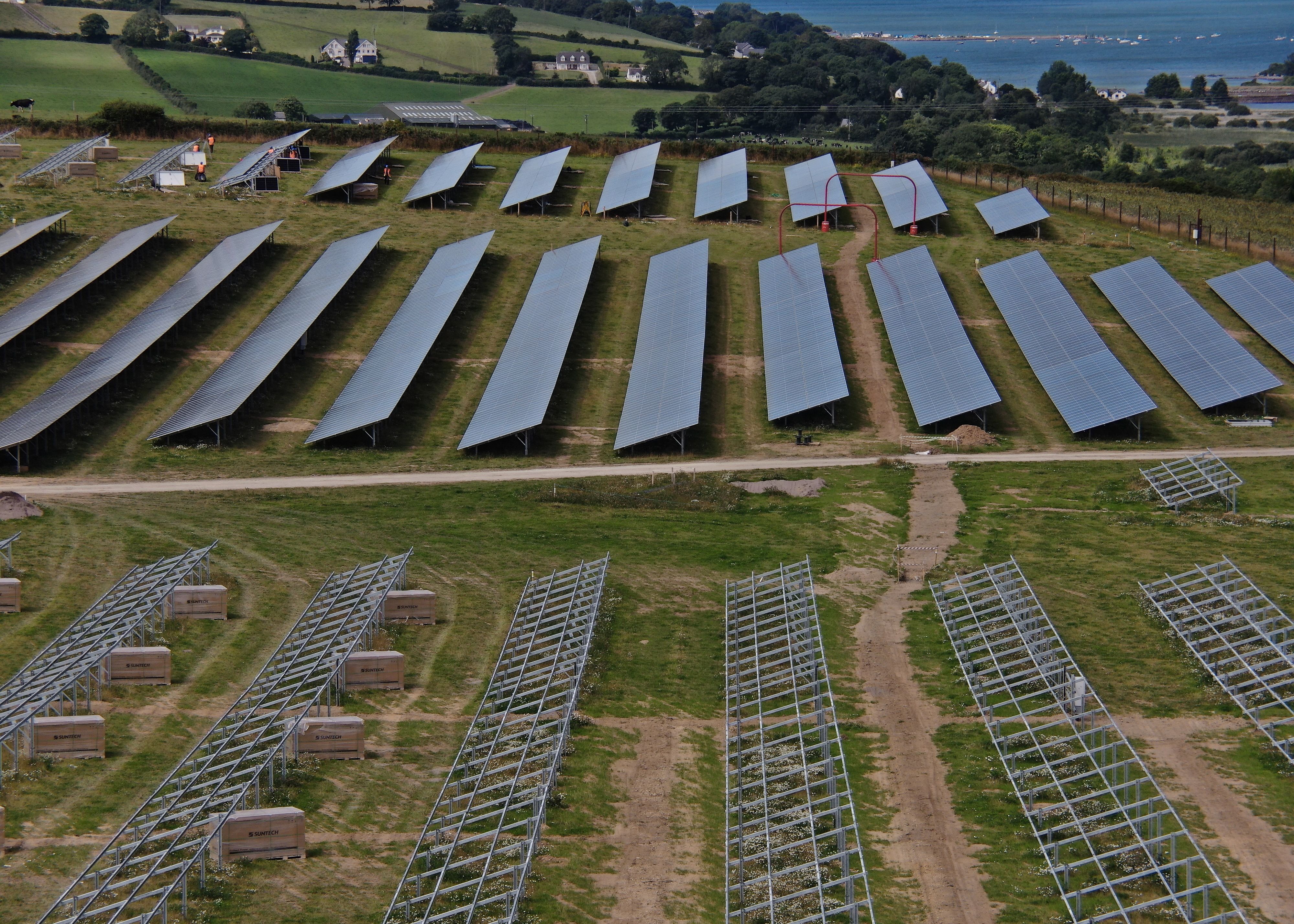A partially completed solar farm under construction