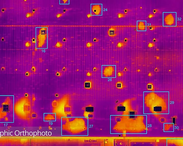 Thermographic orthophoto of a large commercial roof showing water ingress as retained heat