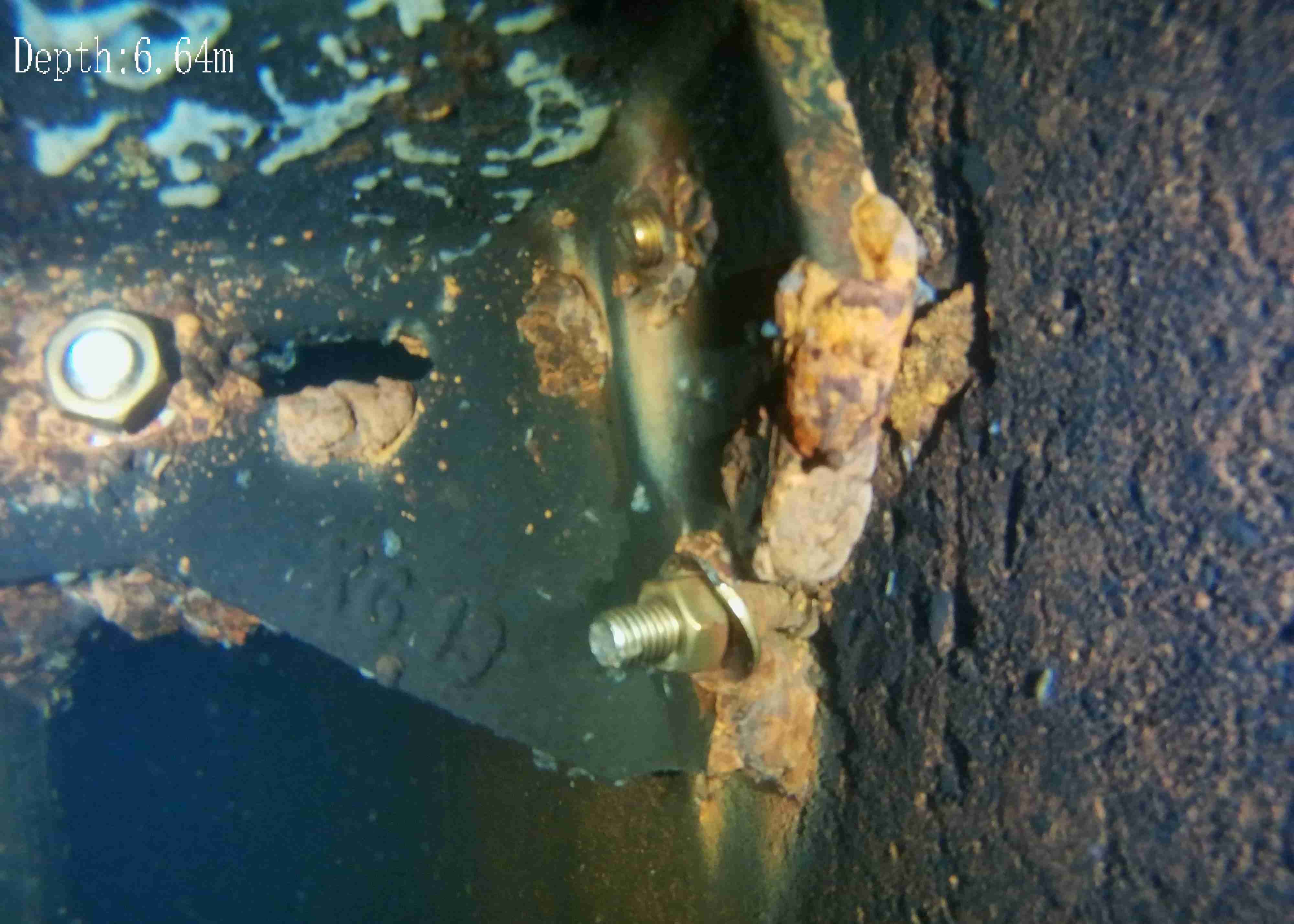 A broken cast iron bracket being inspected