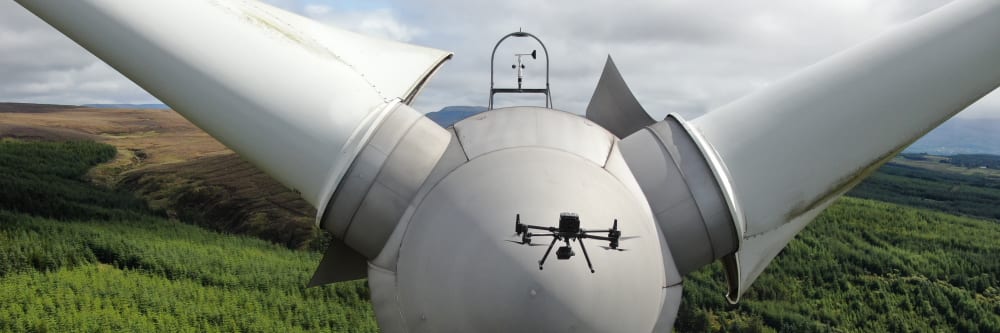 A drone performing a wind turbine inspection